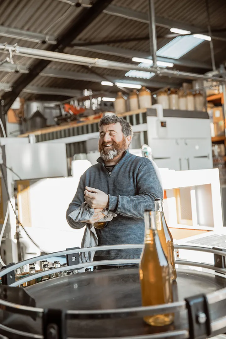 Toby from Hitchcox cider Laughing Cleaning Cider Bottle
